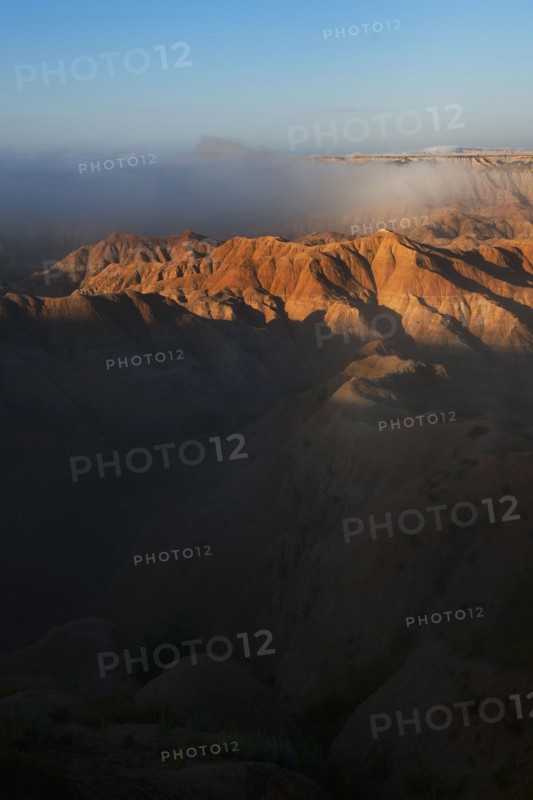 USA, South Dakota, Mountains in morning fog in Badlands National Park.