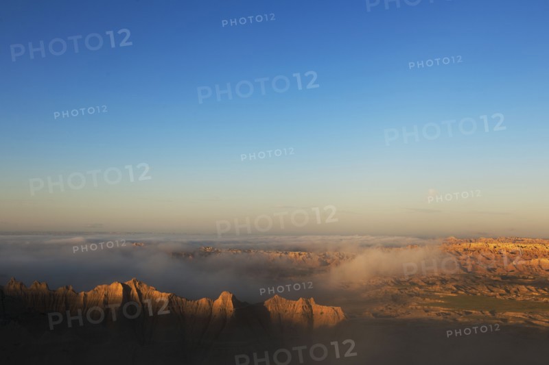 USA, South Dakota, Mountains in morning fog in Badlands National Park.