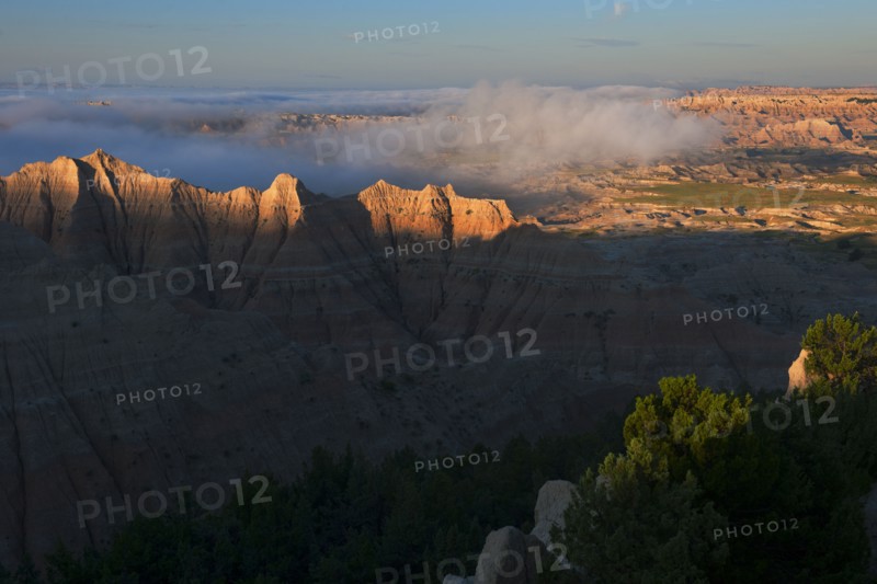 USA, South Dakota, Mountains in morning fog in Badlands National Park.
