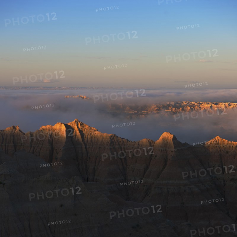 USA, South Dakota, Mountains in morning fog in Badlands National Park.