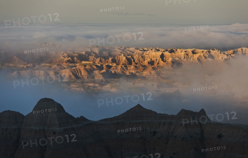 USA, South Dakota, Mountains in morning fog in Badlands National Park.