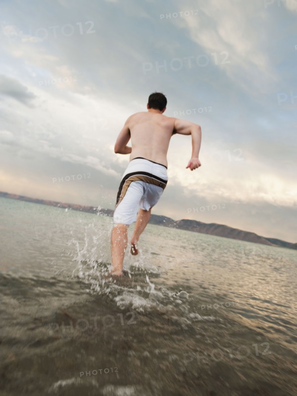 Man running on beach.