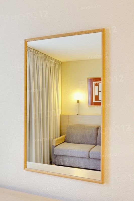 Sofa reflection in mirror of luxury home. Photo : Jon Boyes
