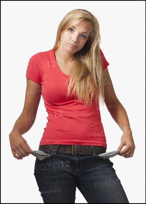 Young woman on white background showing empty pockets. Photo : Mike Kemp