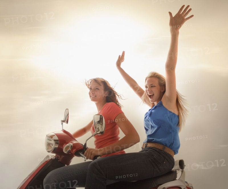 Young girls (16-17) riding scooter. Photo : Mike Kemp