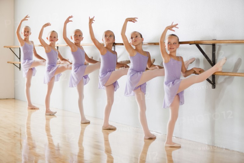 Row of female ballet dancers (6-8) in dance studio. Photo : Mike Kemp