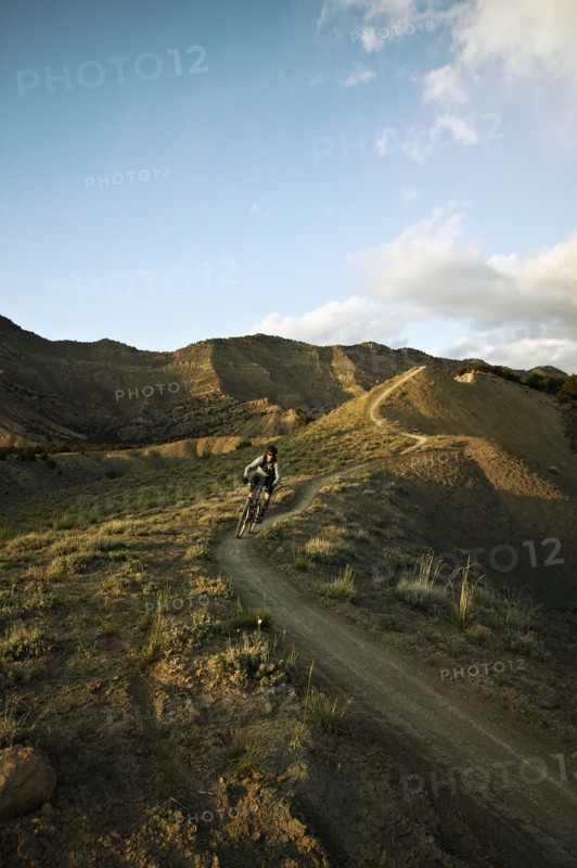Man mountain biking on mountain track. Photo : Shawn O'Connor