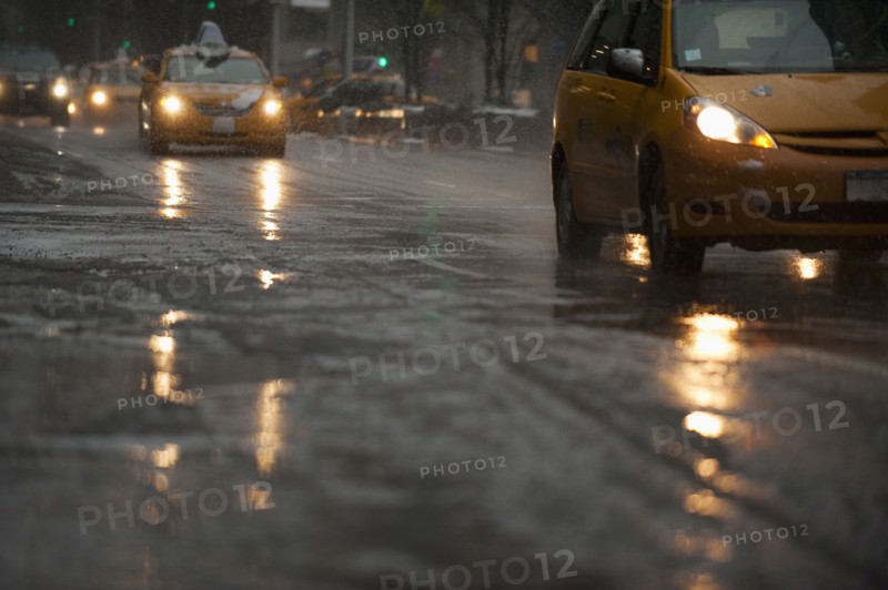USA, New York, New York City, Traffic on street in snow, dusk.