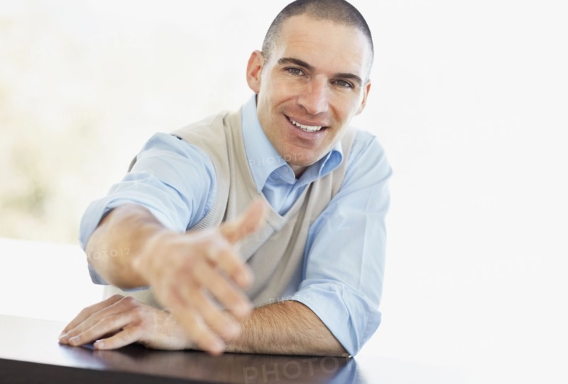 Mid adult man offering hand for handshake. Photo : Momentimages
