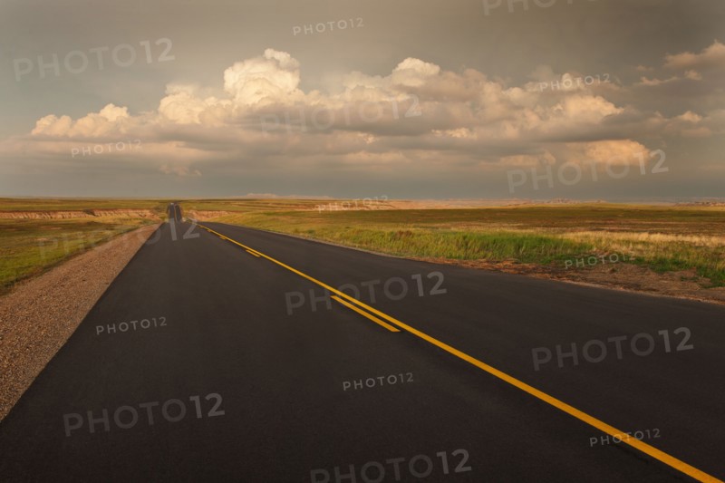 USA, South Dakota, Road in Badlands National Park at sunset.