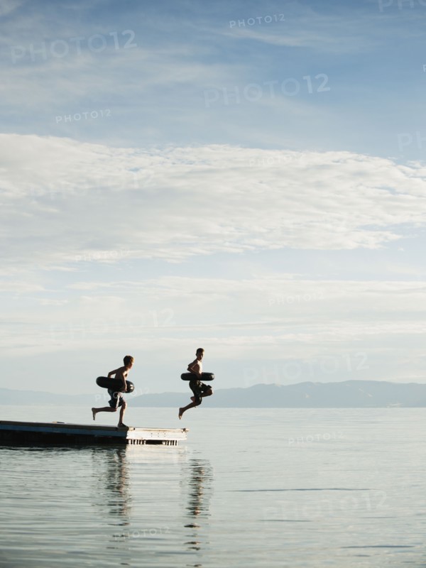 Boys (10-11,12-13) jumping from raft.