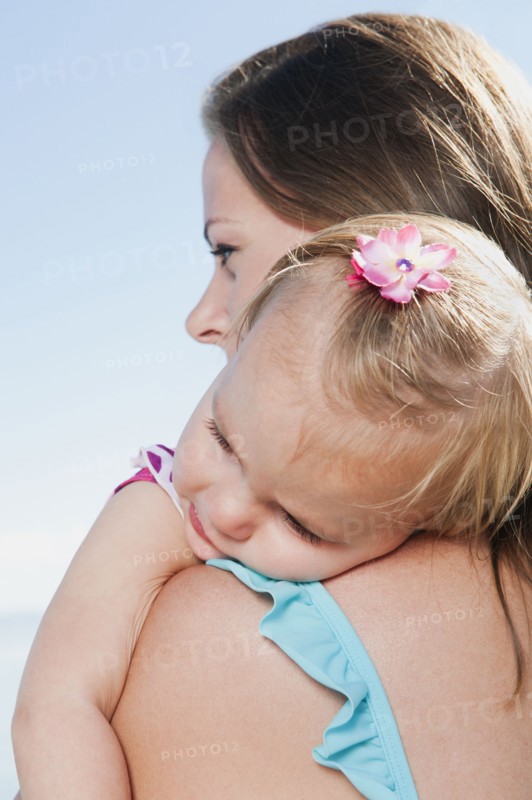 Mother with baby daughter (12-18months) hugging.