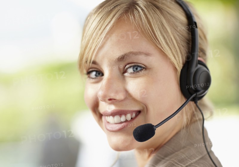Portrait of young female customer service representative. Photo : Momentimages