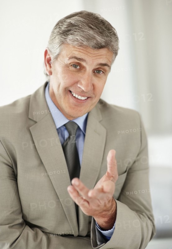 Portrait of cheerful businessman gesturing. Photo : Momentimages
