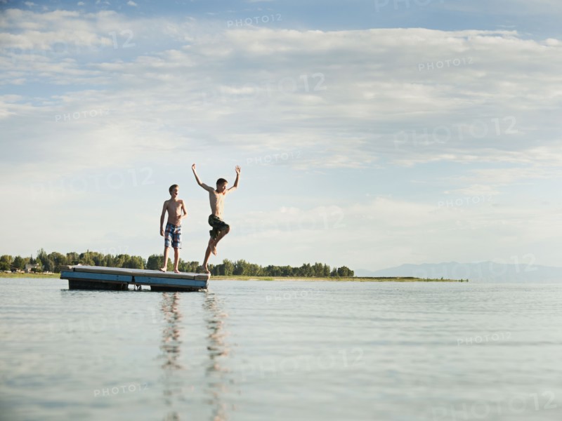 Boys (10-11,12-13) jumping from raft.