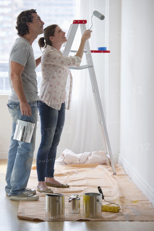 Couple painting walls.