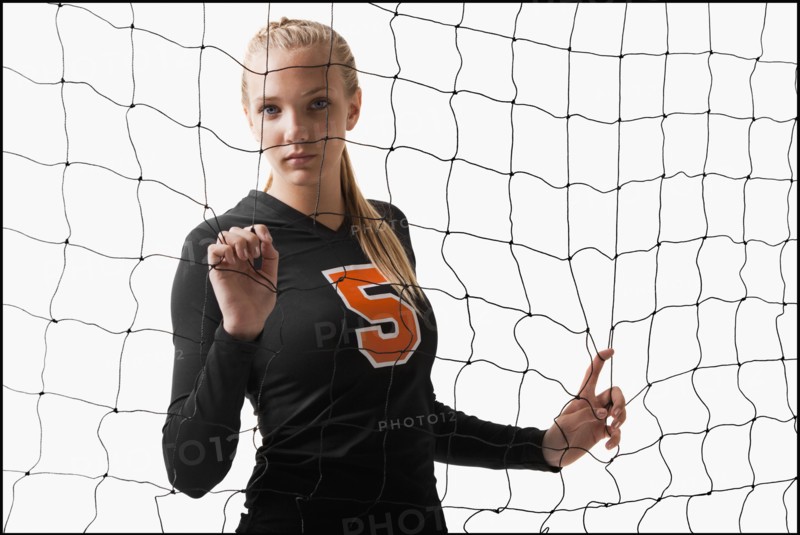 Young girl (16-17) playing volleyball. Photo : Mike Kemp