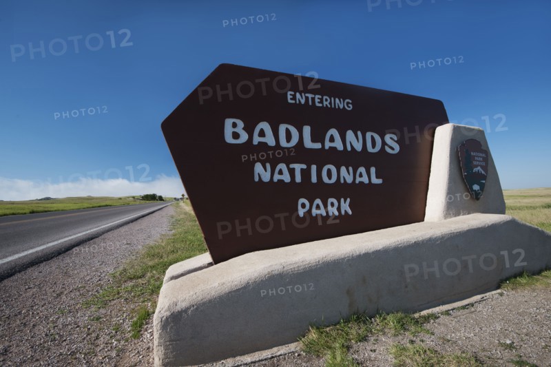 USA, South Dakota, Badlands National Park welcome sign on roadside.