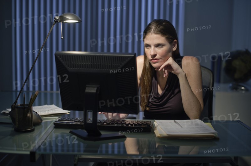 Woman working late in office.