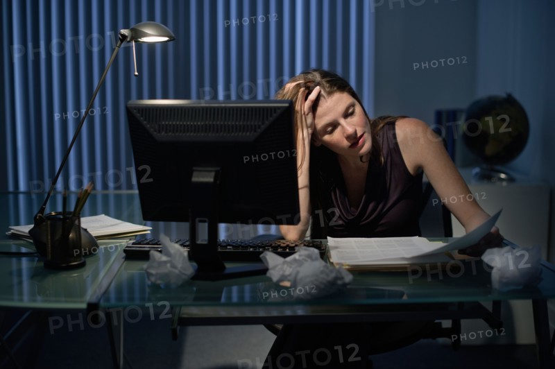Woman working late in office.