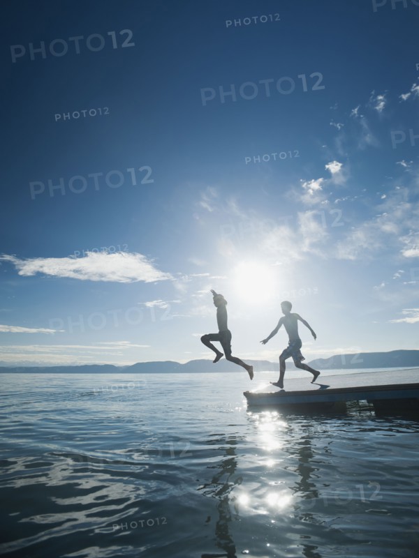 Boys (10-11,12-13) jumping from raft.