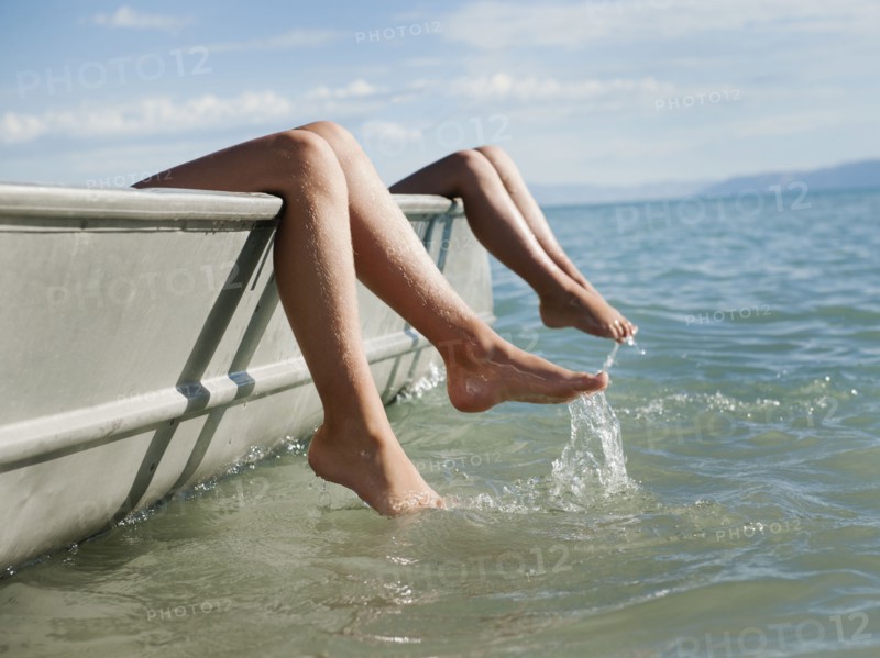 Girls (6-7,8-9) resting on boat.