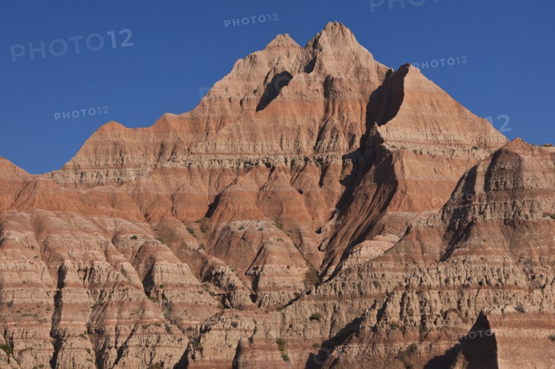 USA, South Dakota, Mountain against blue sky in Badlands National Park.