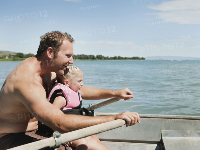 Father and daughter (2-3) on boat.