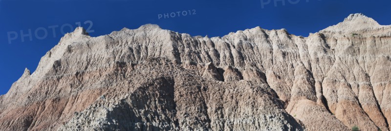 USA, South Dakota, Mountain against blue sky in Badlands National Park.
