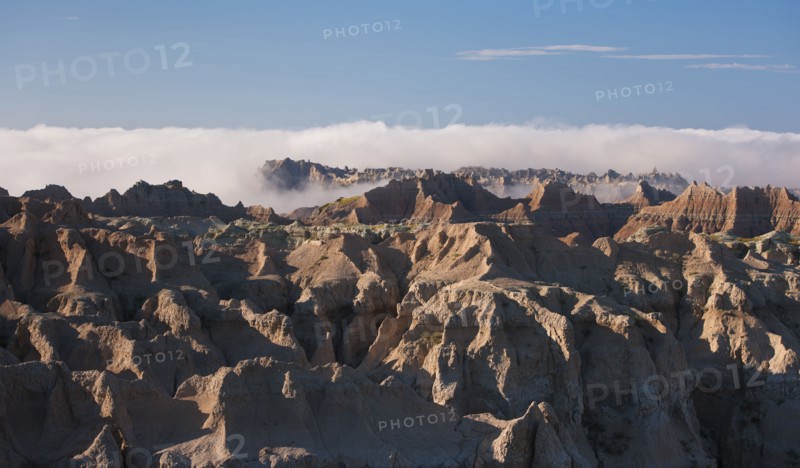USA, South Dakota, Mountains in morning fog in Badlands National Park.