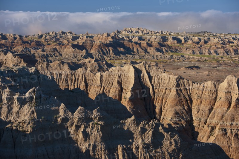 USA, South Dakota, Mountains in morning fog in Badlands National Park.