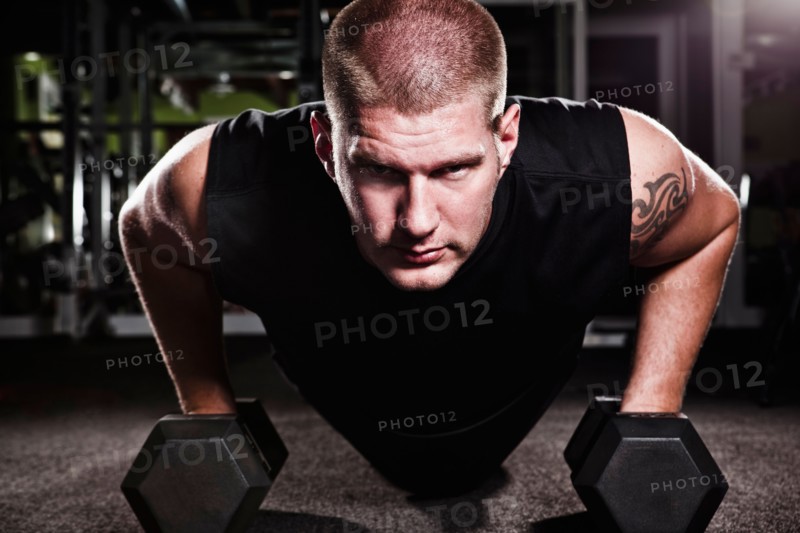 Mid adult man working out in gym. Photo : Take A Pix Media