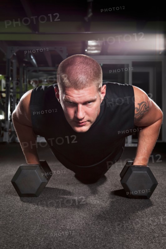 Mid adult man working out in gym. Photo : Take A Pix Media