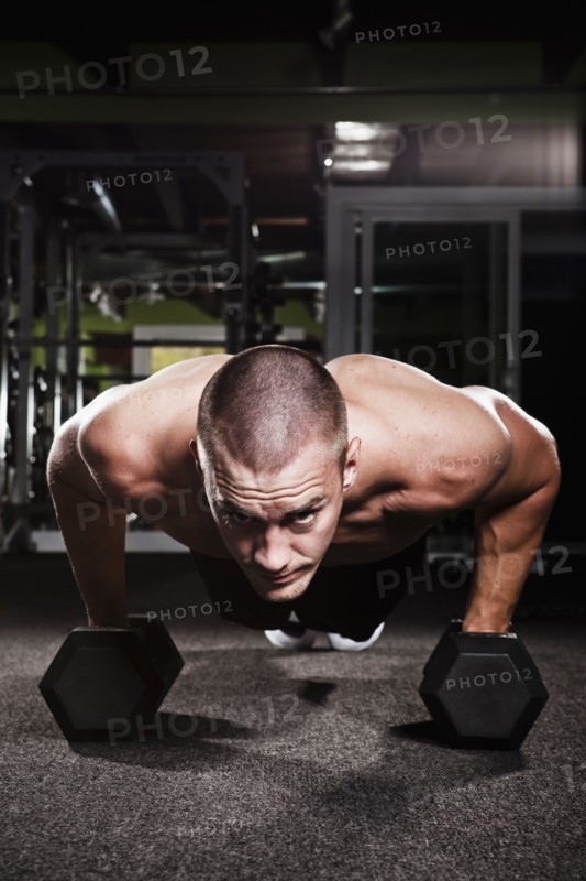 Mid adult man working out in gym. Photo : Take A Pix Media