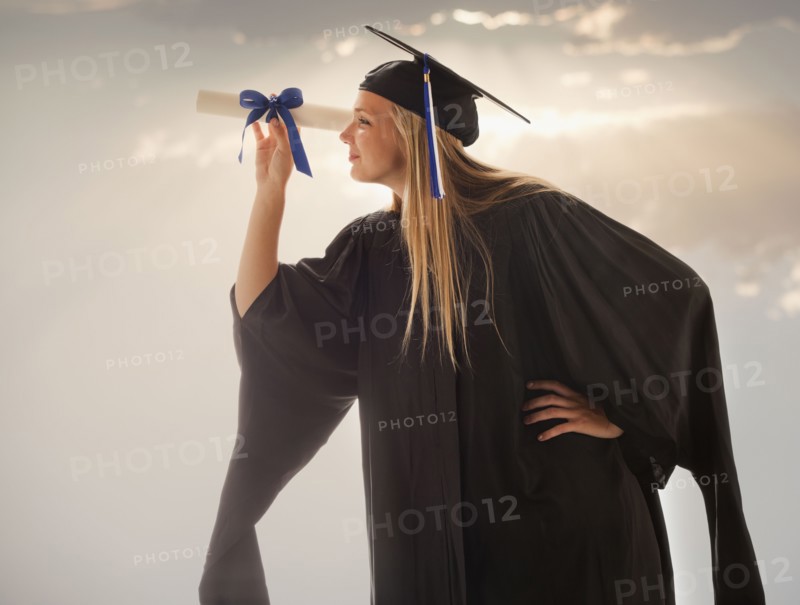 Young girl (16-17) wearing graduating gown. Photo : Mike Kemp