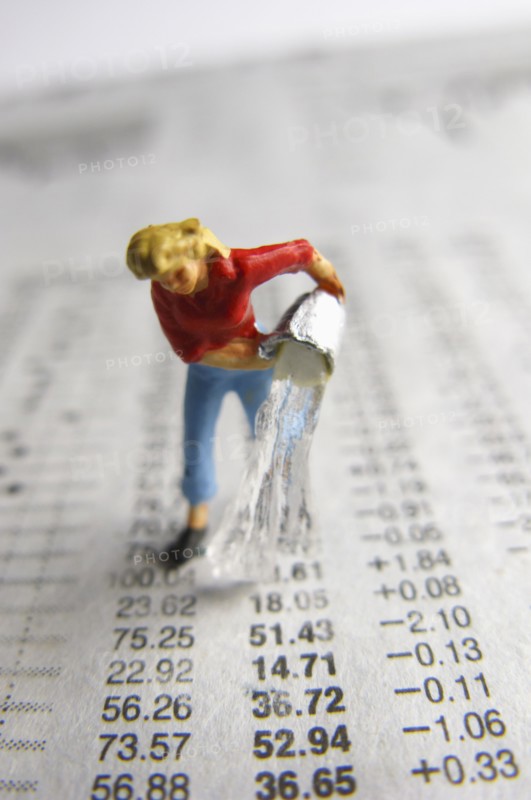 Model woman pouring water on financial figures. Photo : Antonio M. Rosario