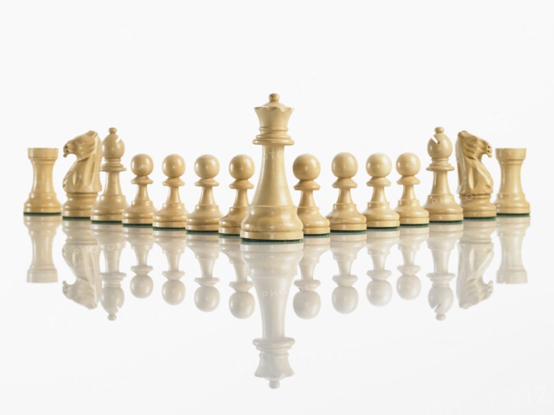King with team of chess pieces. Photo : David Arky