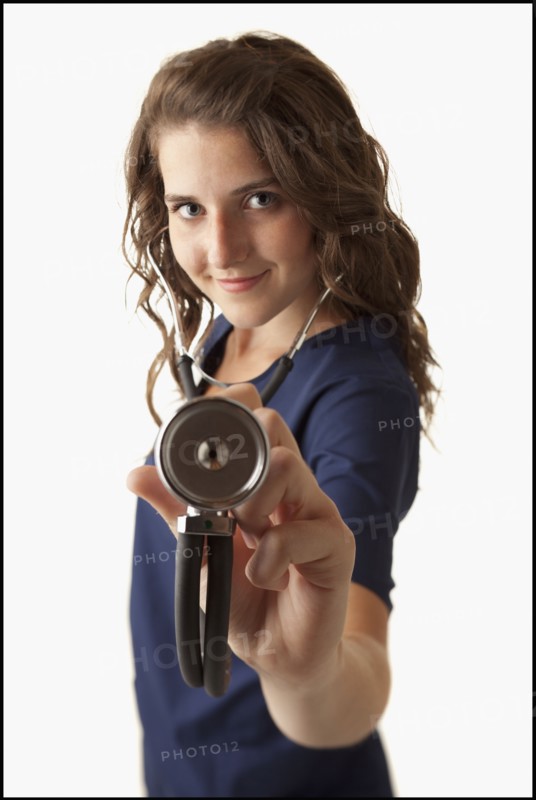 Portrait of young nurse holding stethoscope. Photo : Mike Kemp