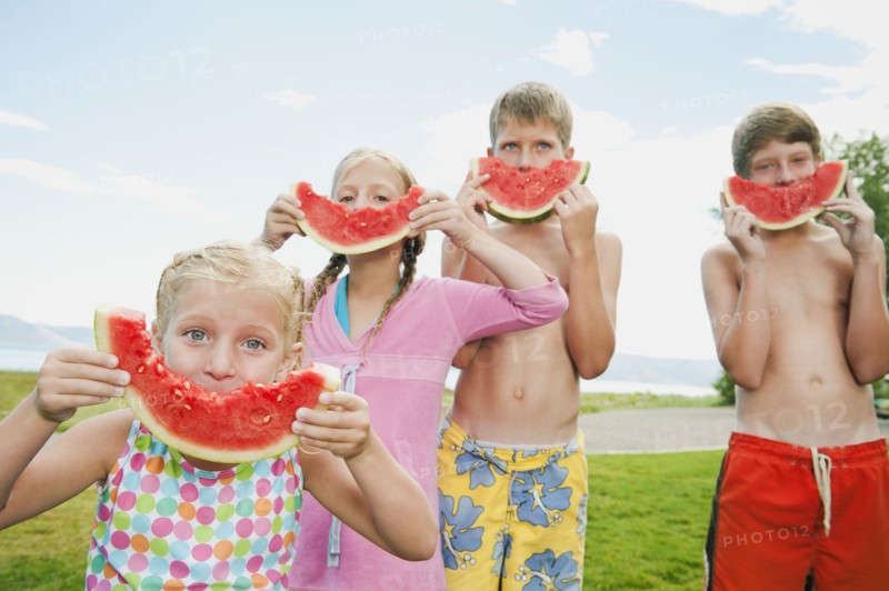 Kids (6-7,8-9,10-11,12-13) eating watermelon.