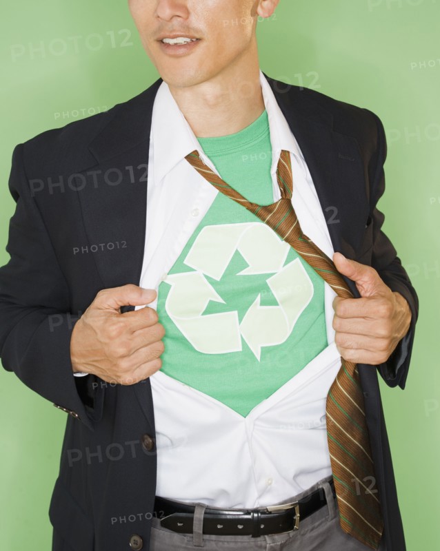 Businessman with wearing t-shirt with recycling symbol under suit, studio shot. Photo : Jamie Grill