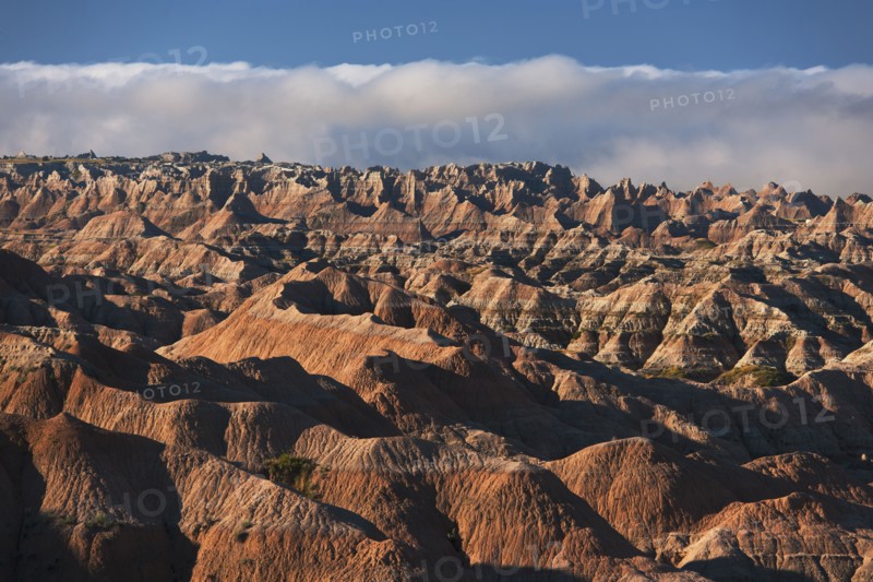 USA, South Dakota, Mountains in morning fog in Badlands National Park.