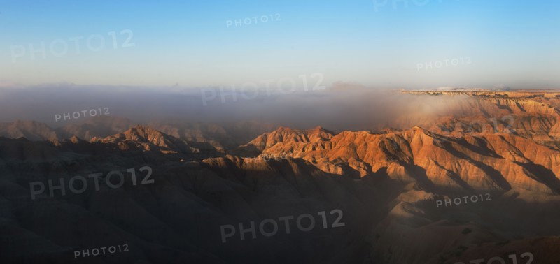 USA, South Dakota, Mountains in morning fog in Badlands National Park.