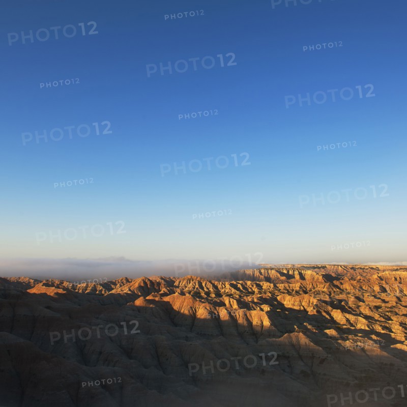 USA, South Dakota, Mountains in morning fog in Badlands National Park.