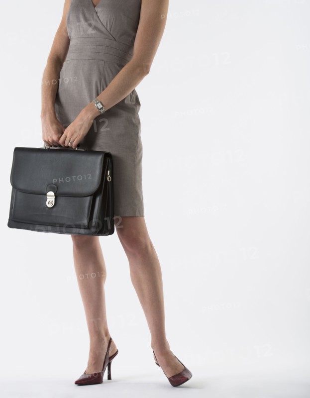 Young woman with briefcase, studio shot.