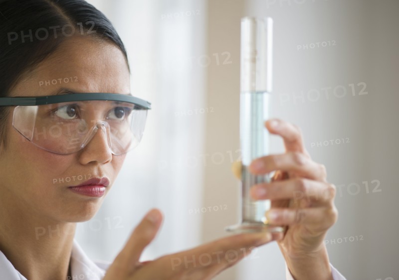 USA, New Jersey, Jersey City, Female scientist holding chemical test tube.