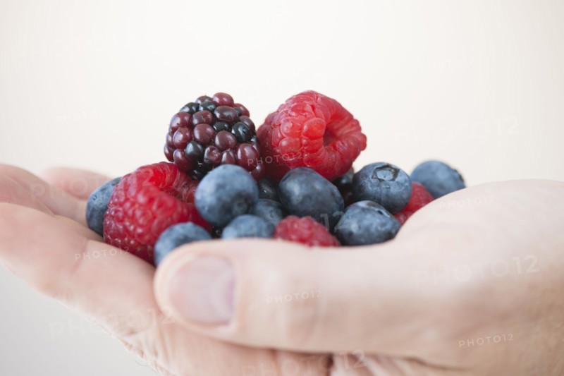Fresh fruits on male hand.
