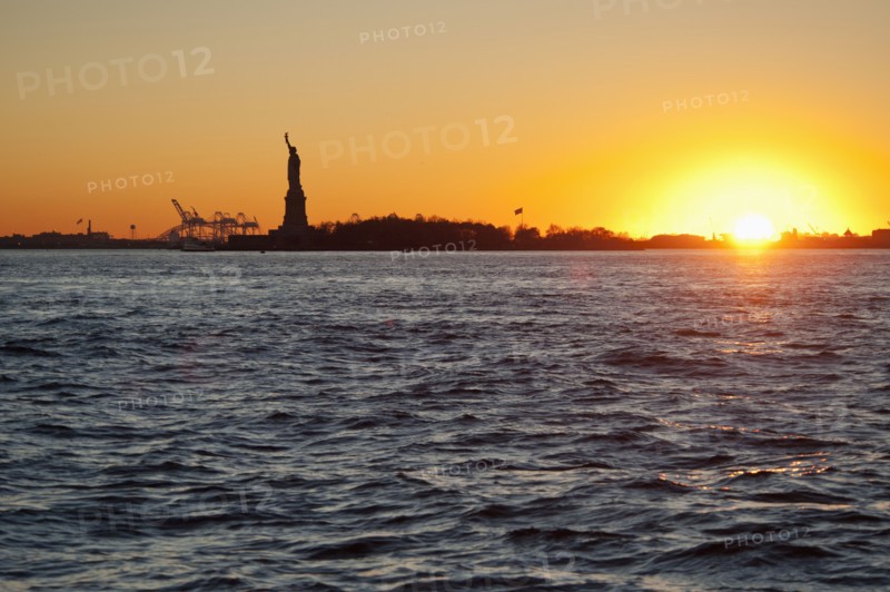 USA, New York City, Staten Island, Harbor and silhouette of Statue of Liberty in background.