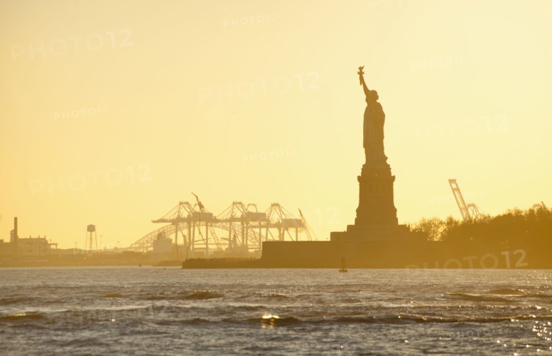USA, New York City, Staten Island, Harbor and silhouette of Statue of Liberty in background.