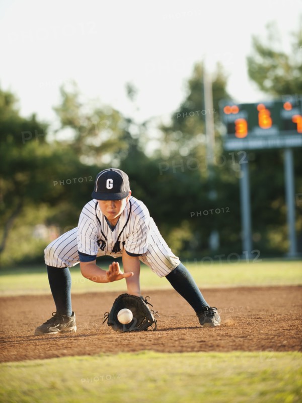 Boy (10-11) playing baseball.