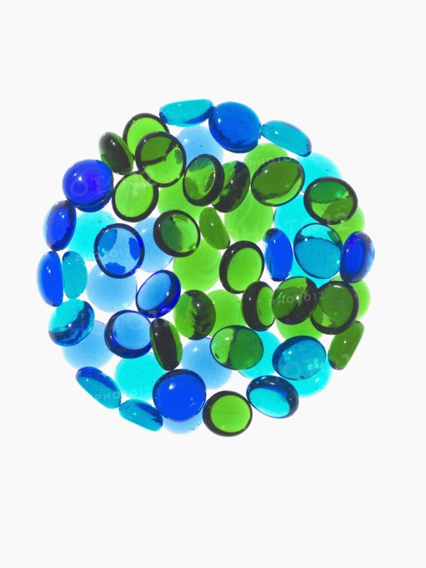 Studio shot of blue and green glass beads in sphere. Photo : David Arky